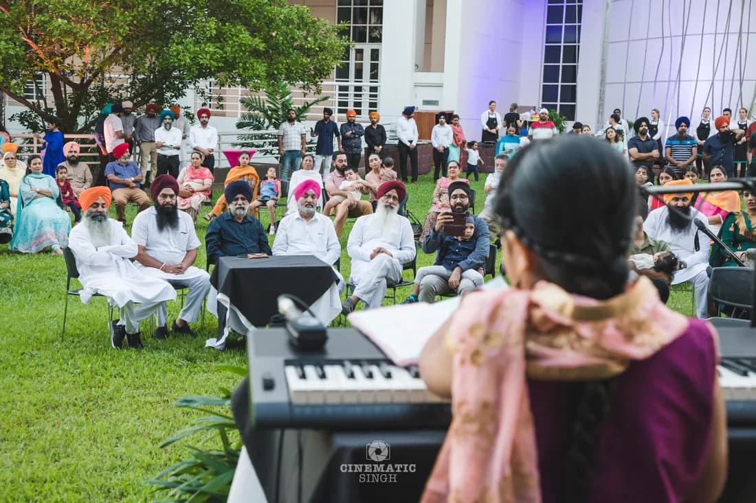 Young Sikh student performing Kirtan before the Darwin Sangat